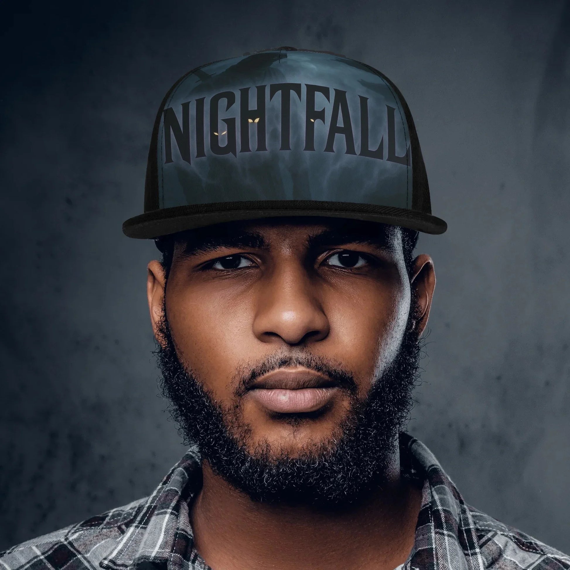 Portrait of a man with a beard wearing a "Nightfall" hat.
